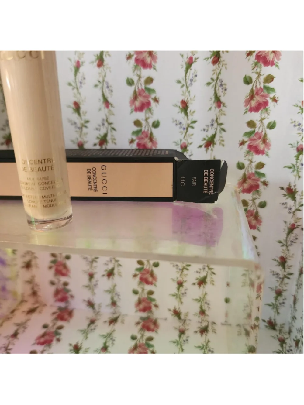 Gucci concealer with pink and green floral design on white background #gucci #fl